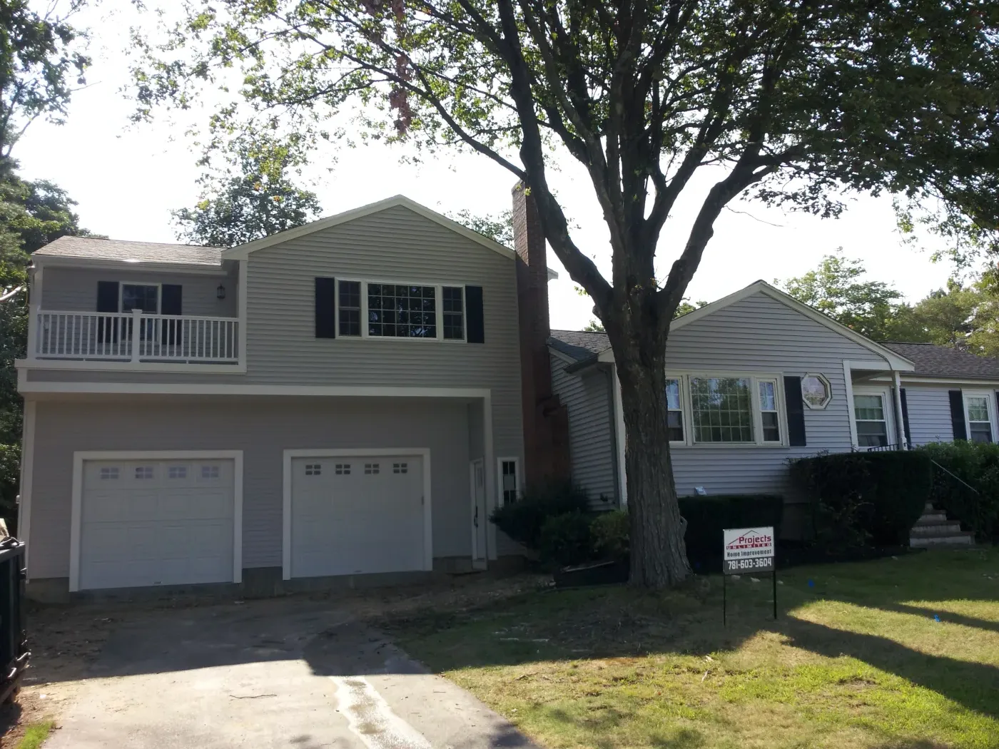 Two-story addition with garage and balcony finished by Projects Unlimited Construction